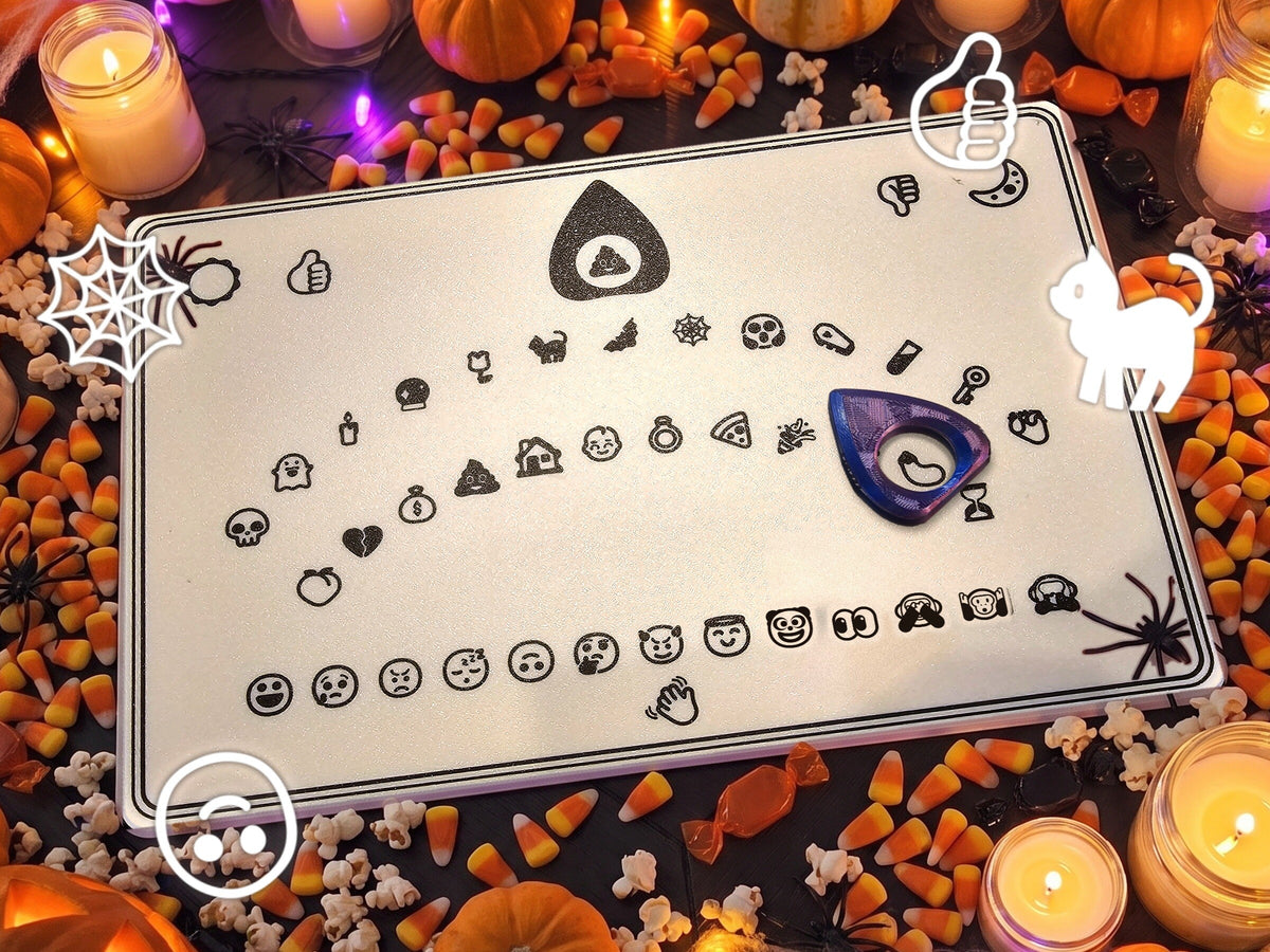 Emoji spirit board on a candlelit Halloween party table with pumpkins and candy corn, the purple planchette on the eggplant emoji
